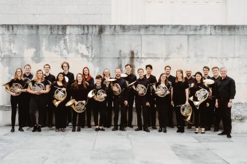 the ut horn choir hold their instruments