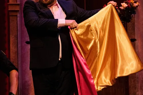 A matador flaunts his multi-colored cape for onlookers