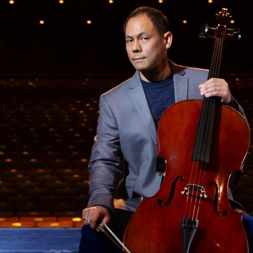 Bion Tsang in a concert hall with his cello