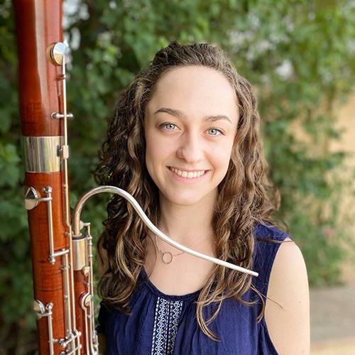 Brigit Fitzgerald poses with her bassoon and smiles into camera