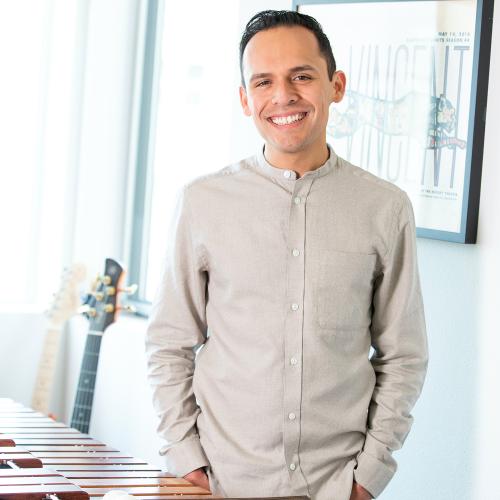 Ivan Trevino stands at a marimba and smiles