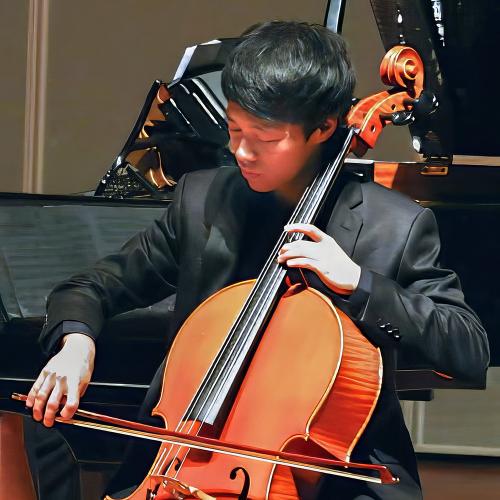 Wong plays his cello as part of an orchestra performance