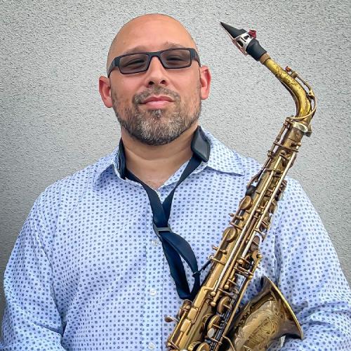 Gene Centeno poses confidently with his saxophone
