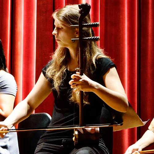 Heather couture plays a Kamencheh, a middle eastern stringed instrument, during a staged concert