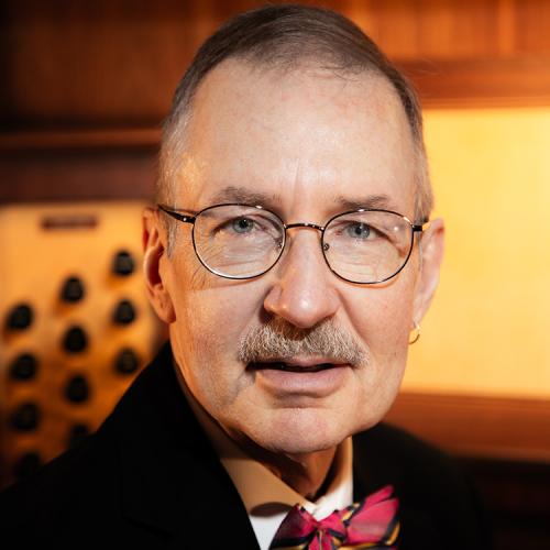 A headshot of Gregory Eaton sitting at the organ console