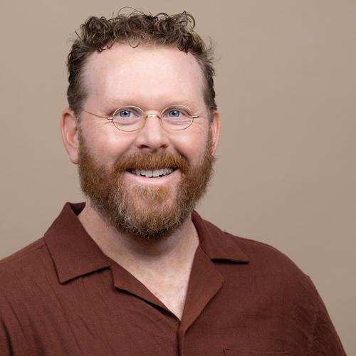 A headshot of Travis Weller