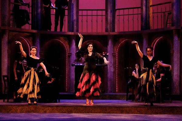 Carmen performs a seductive dance, accompanied by two other female dancers.