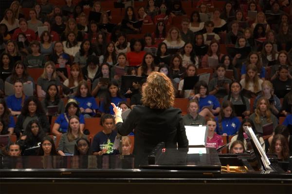 Suzanne Pence conducting in front of a choir