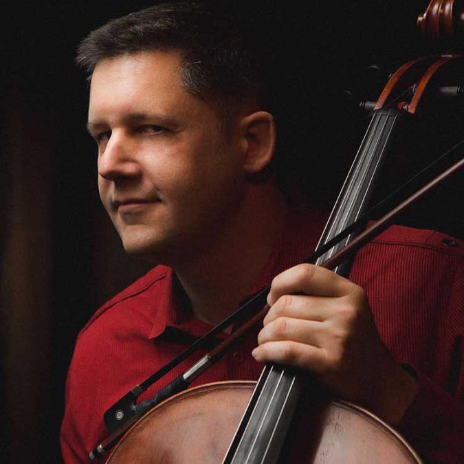 a headshot of Nick Photinos with his cello