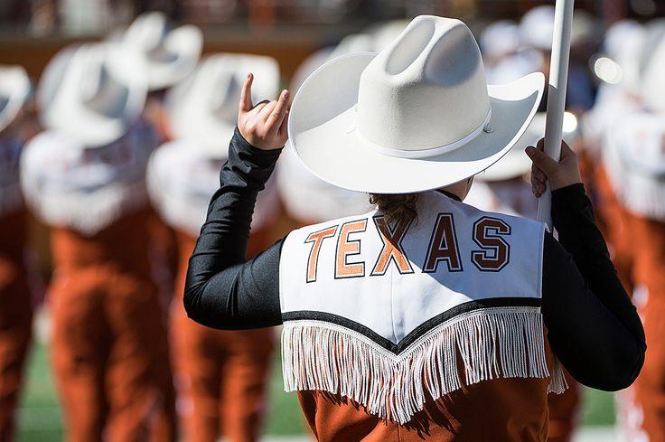 Longhorn Band member gives hook 'em horns sign