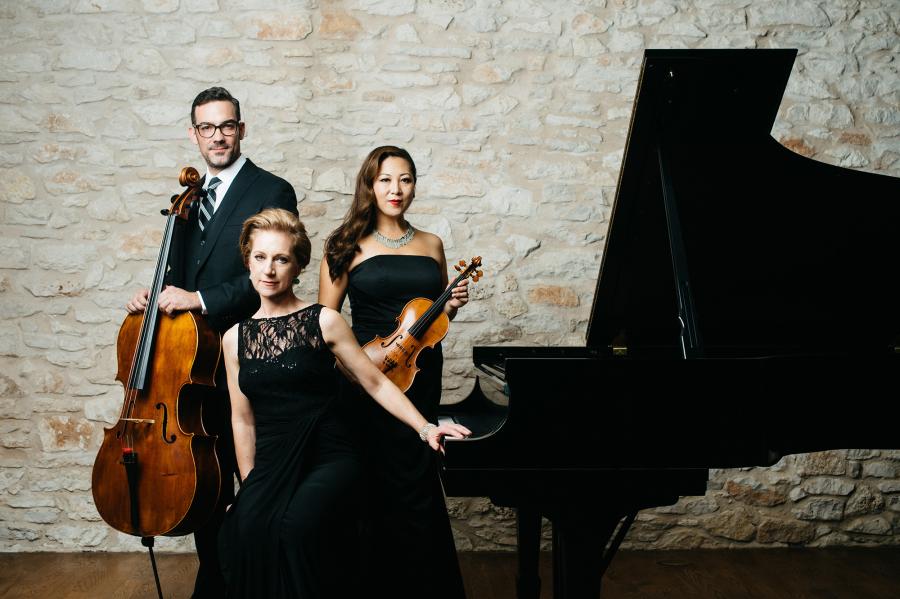 Joshua Gindele, Sandy Yamamoto and Colette Valentine wearing concert black next to an open grand piano.