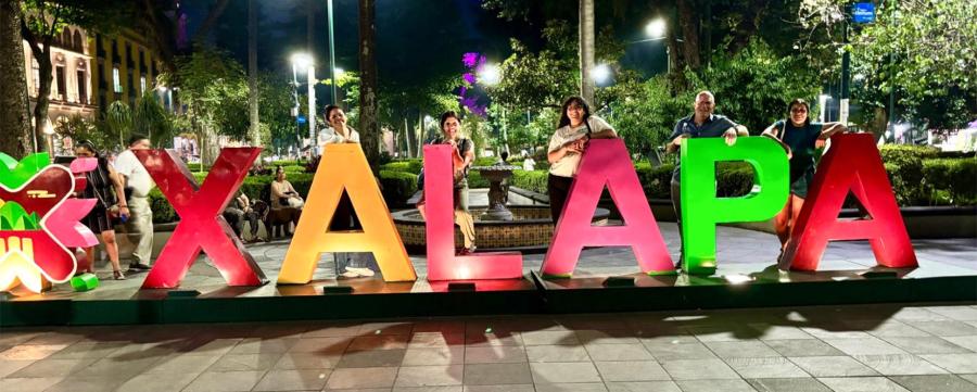 People standing by huge letters spelling XALAPA