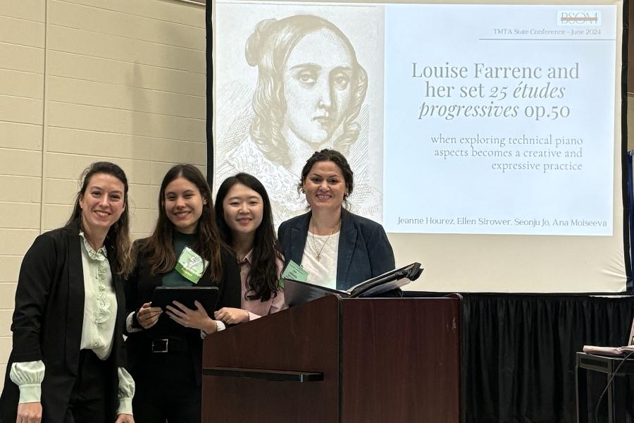 4 students presenting at a conference