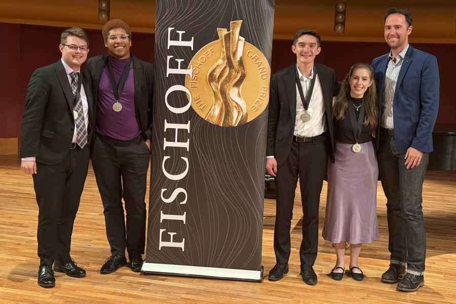 Members of Zed on stage with their professor Stephen Page