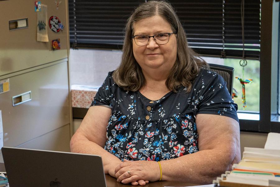 Anne Hall sitting behind a desk