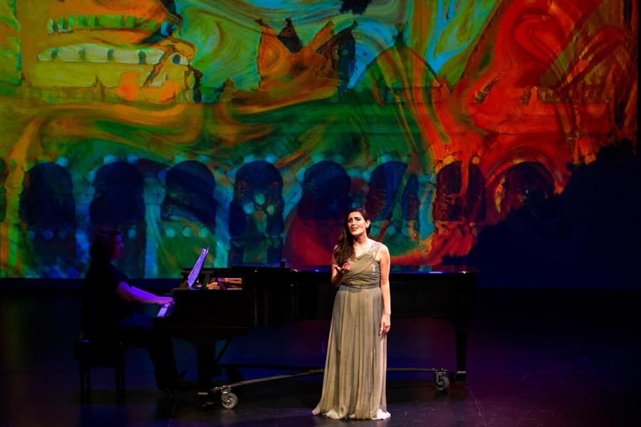 Mezzo soprano Talin Nalbandian singing in front of a watercolor background.