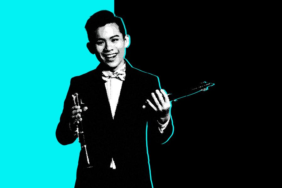 Black and white photo of a student holding a clarinet in front of an aqua and black background.