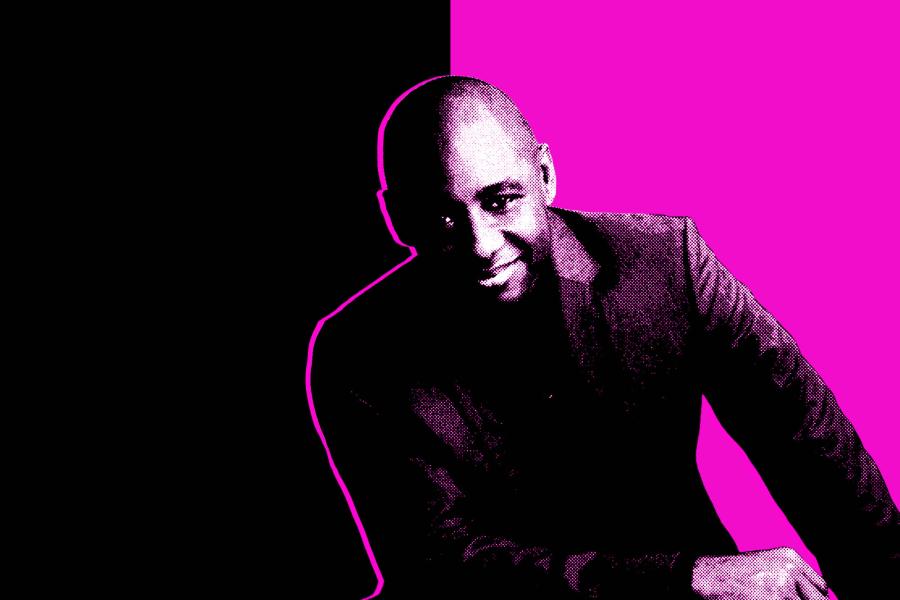 A black and white headshot of Branford Marsalis in front of a magenta and black background.