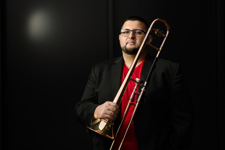 Altin Sencalar standing with a trombone