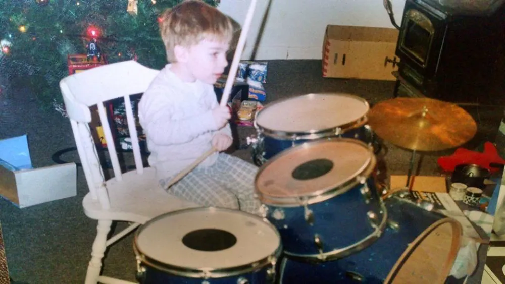 Reese R Maultsby as a kid playing a drumset