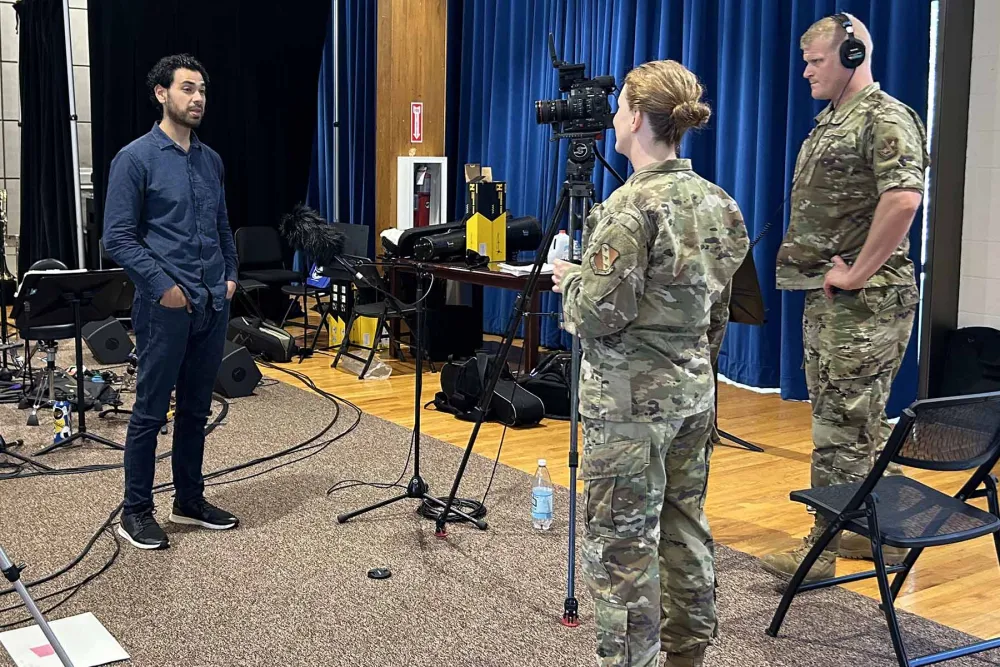 David Mesquitic being interviewed by two air force personal 