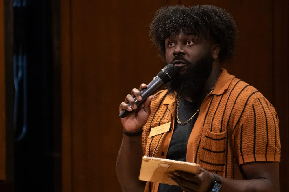 Joseph Reese talking into a mic