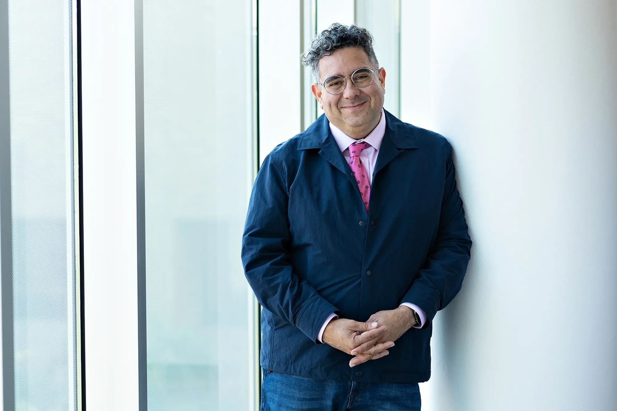 Rivera-Servera looks warmly into camera, from the lobby of the Performing Arts Center