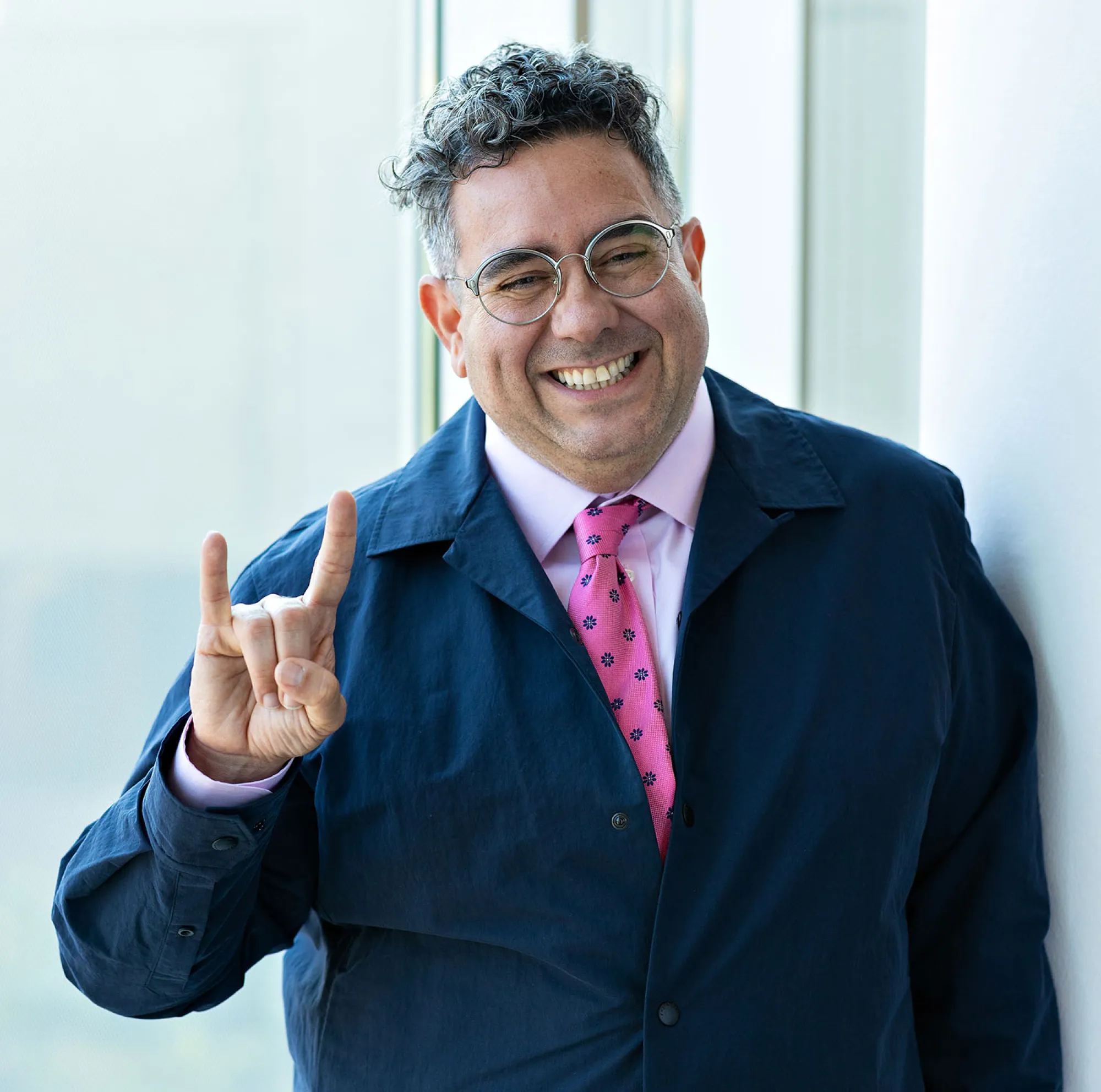 Rivera-Servera holds up Hook 'em horns.