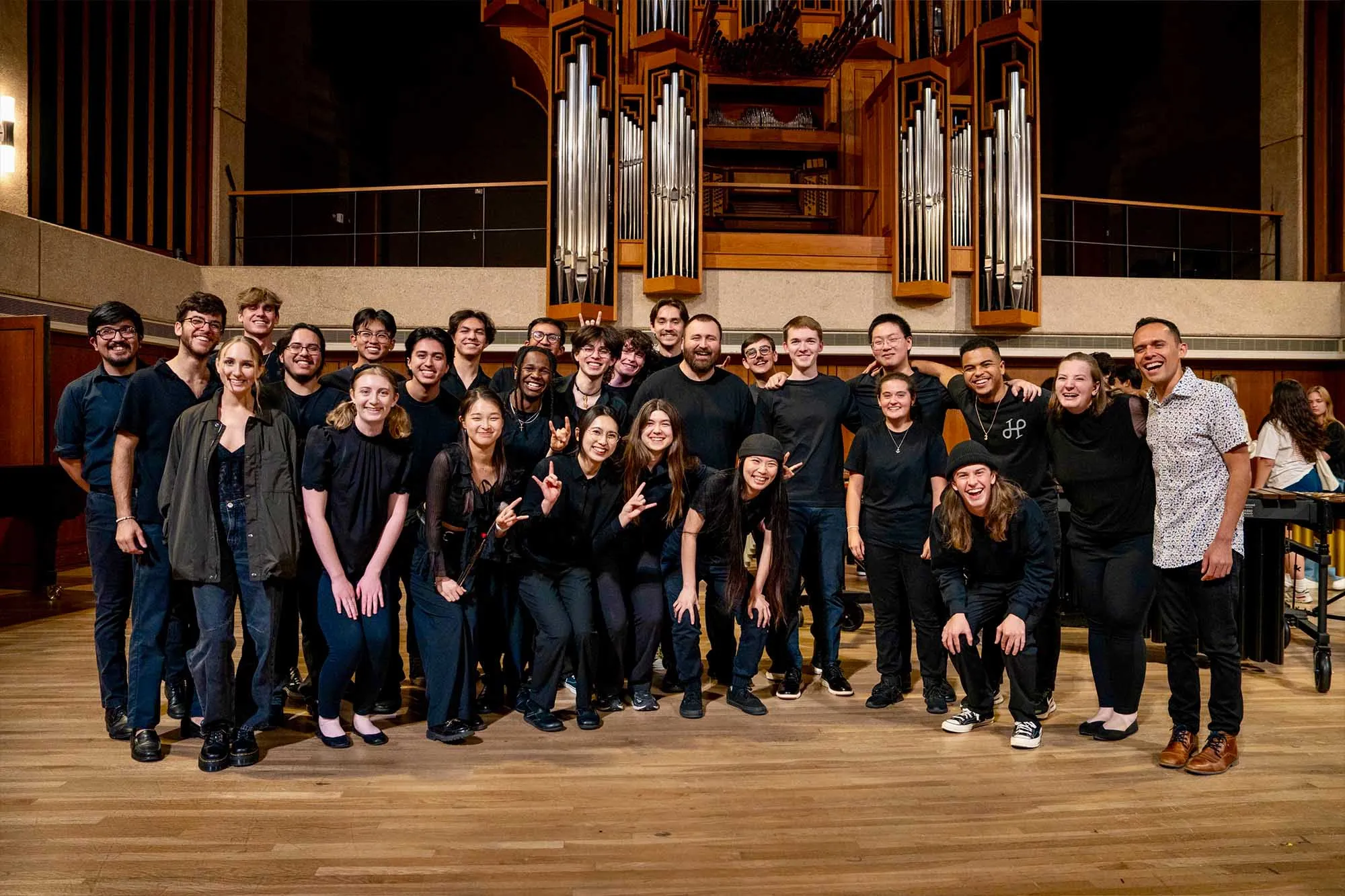 About 30 students on stage posing for a picture