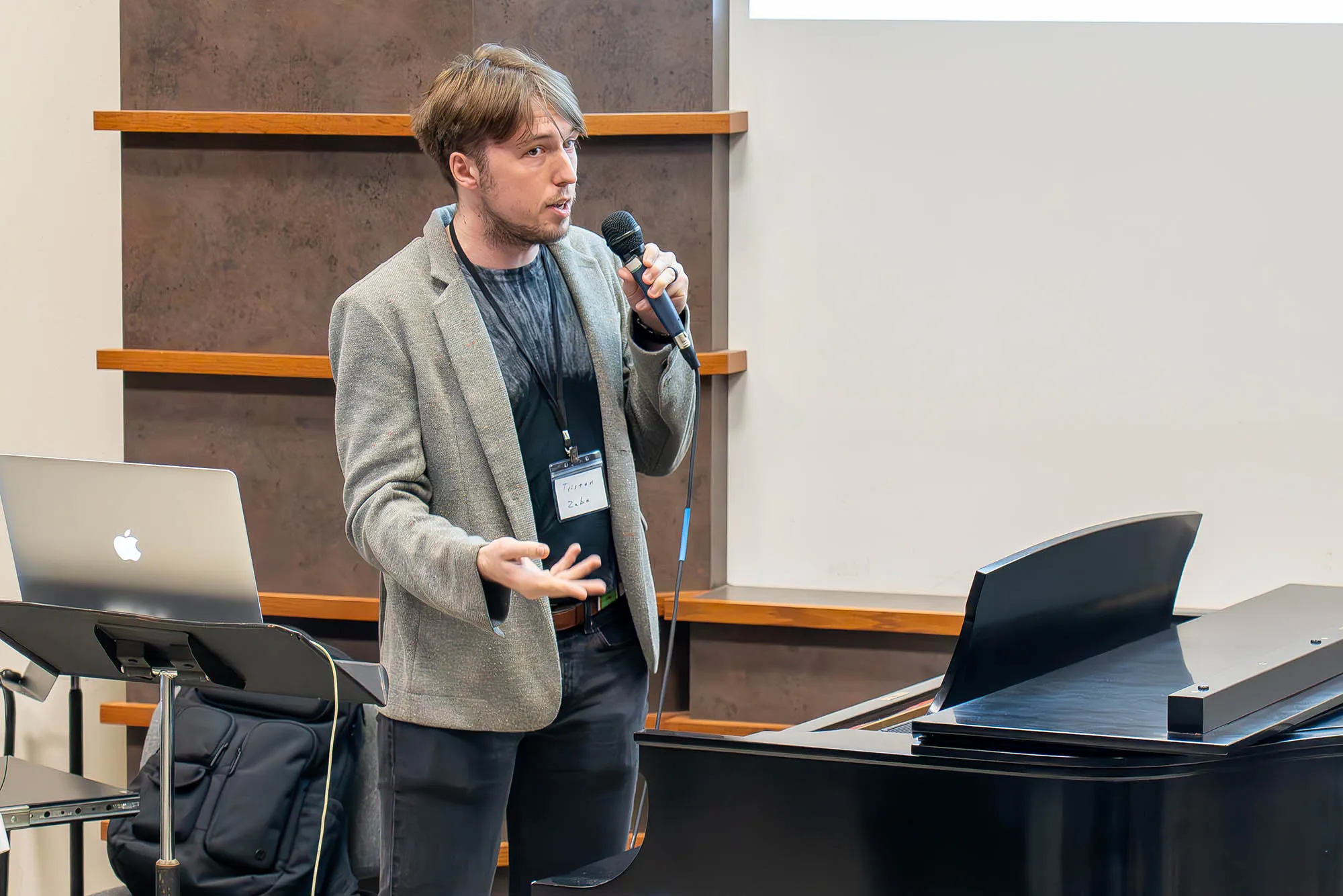 Tristan Zaba talks into a mic