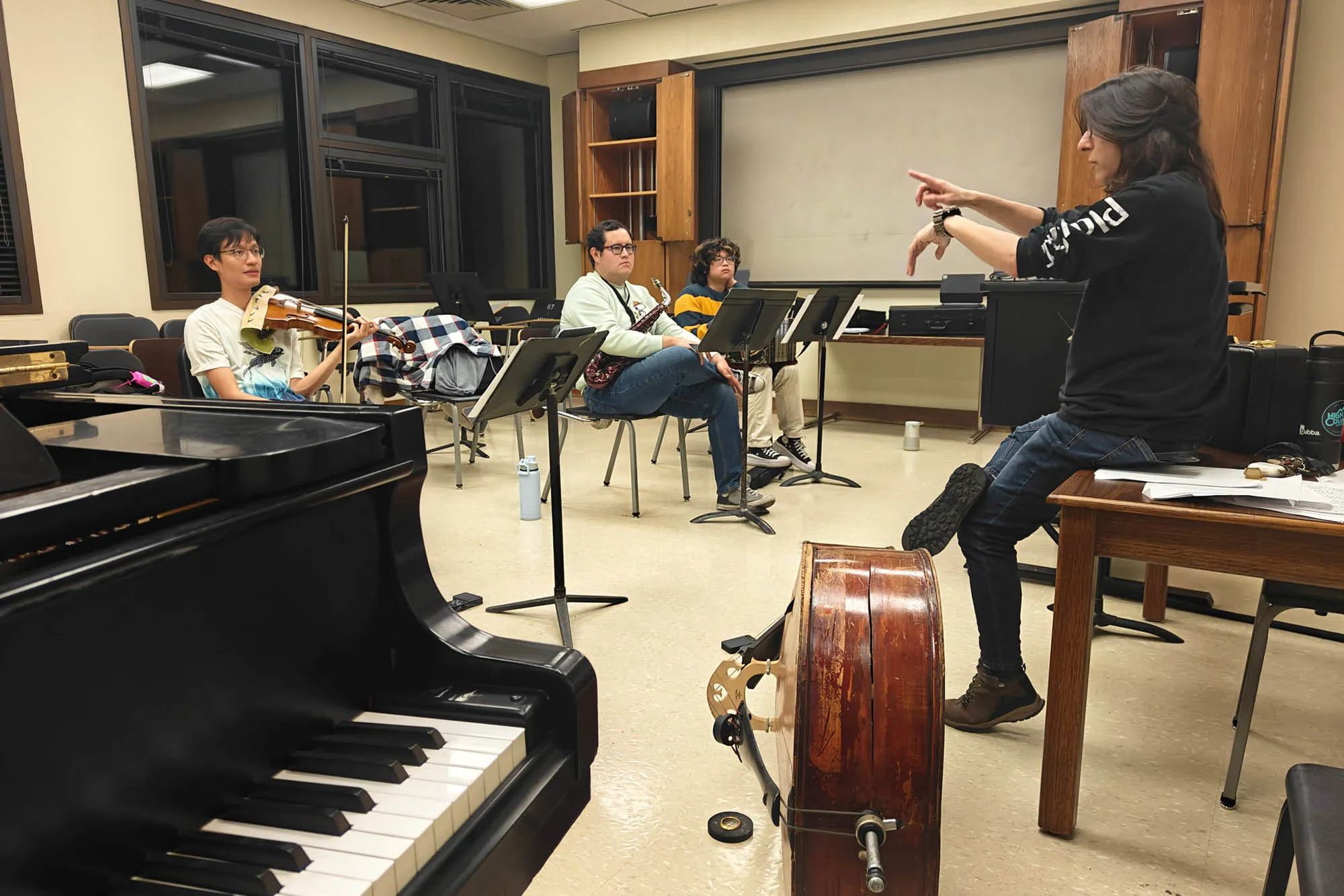 A teacher teaches in a college classroom