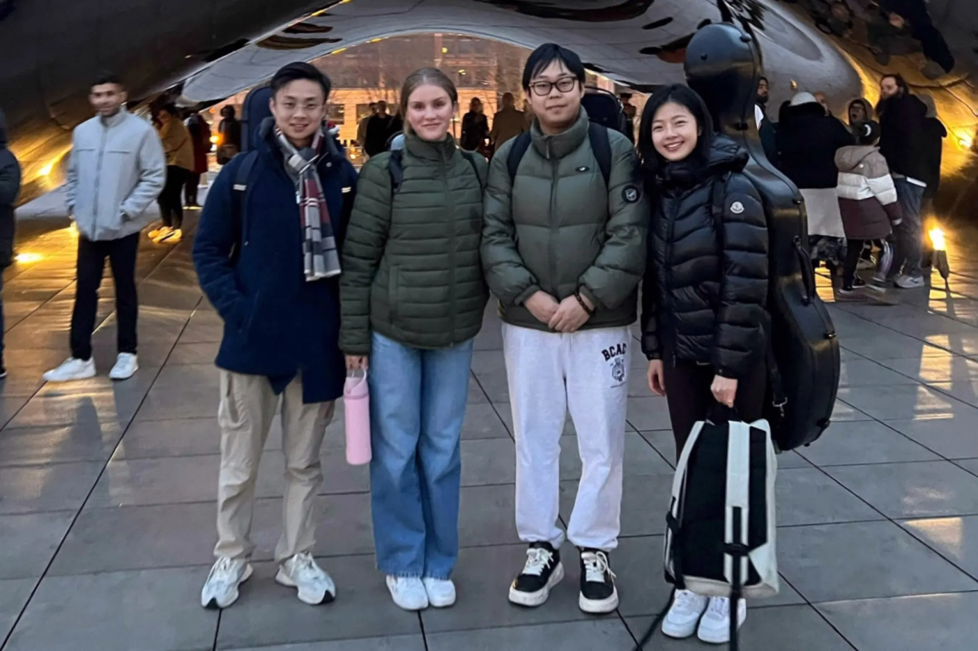 Canelé quartet standing on a street in a city