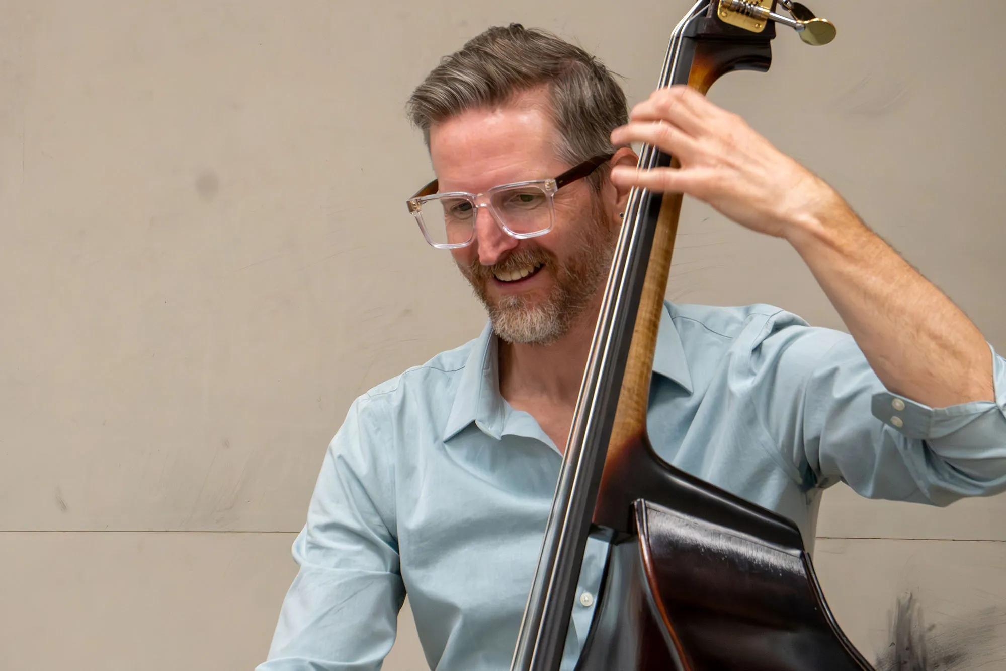 A bass player plays a stand up bass