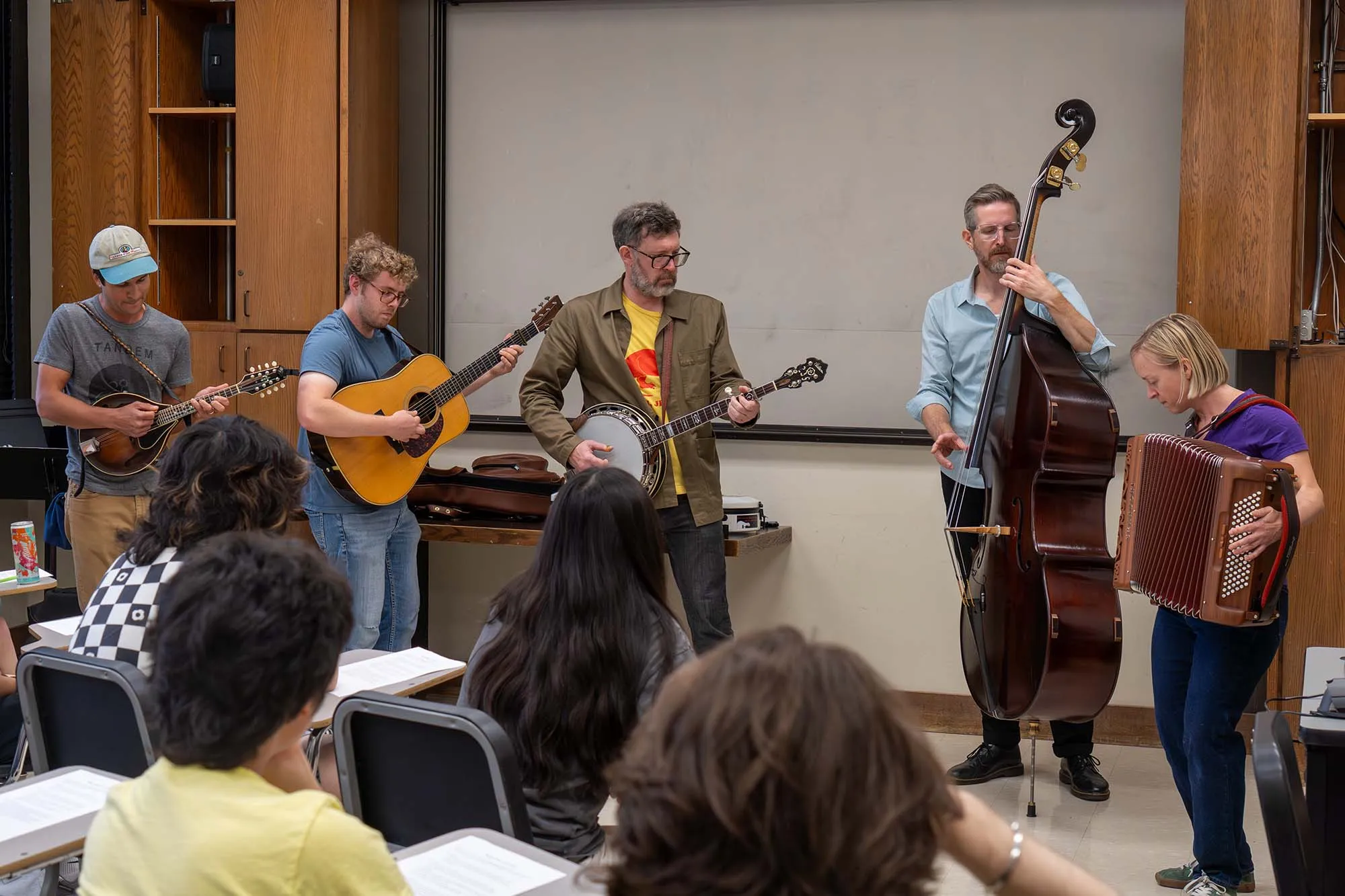 A bluegrass band plays in front of a classroom