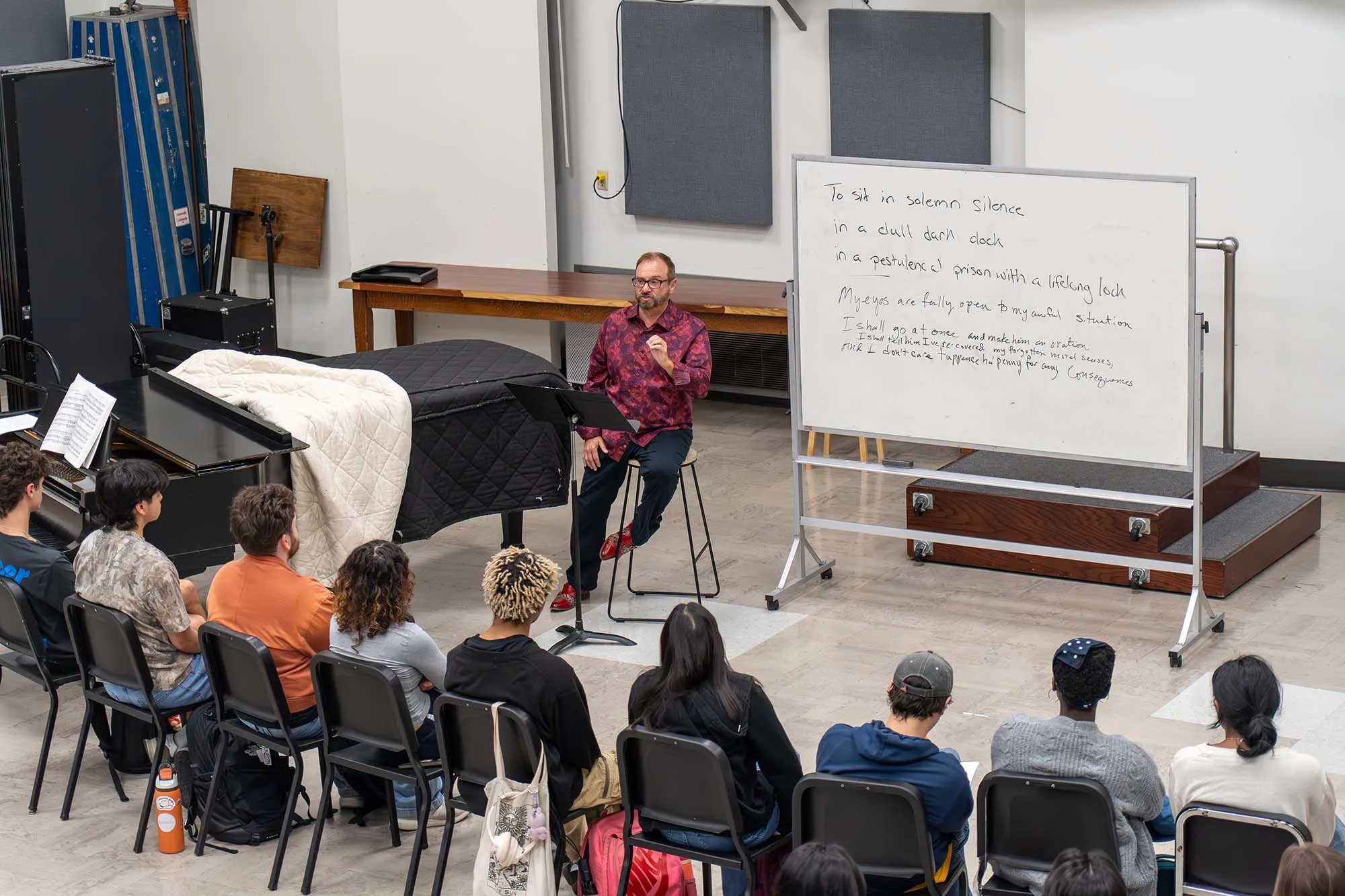 Jeffrey Jones-Ragona lectures to a class in front of a white board