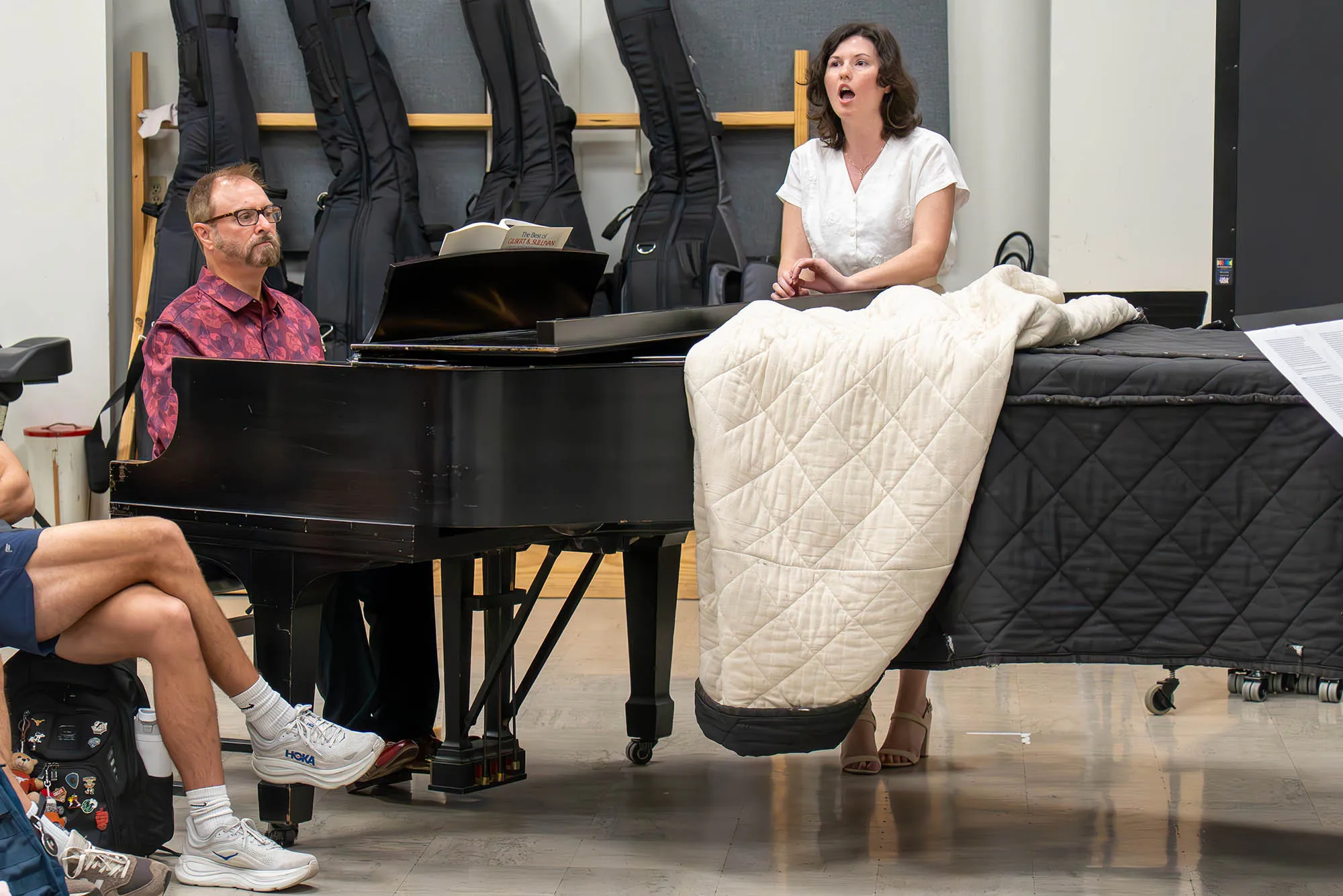 Jeffrey Jones-Ragona plays the piano while Hannah Neuhauser sings
