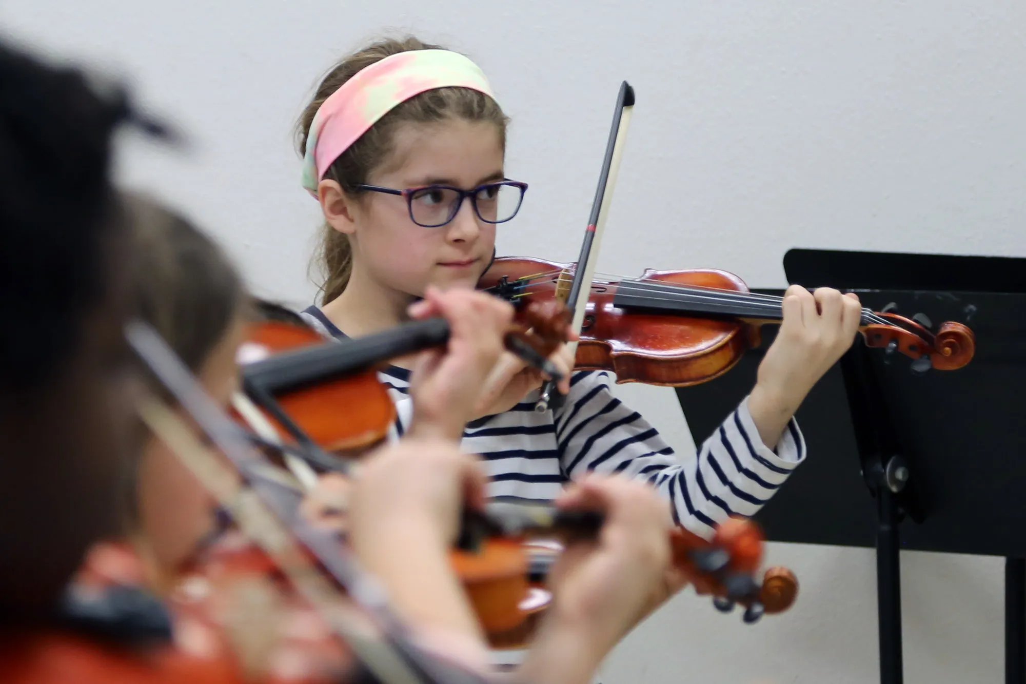 A Student Plays the Violin in a class