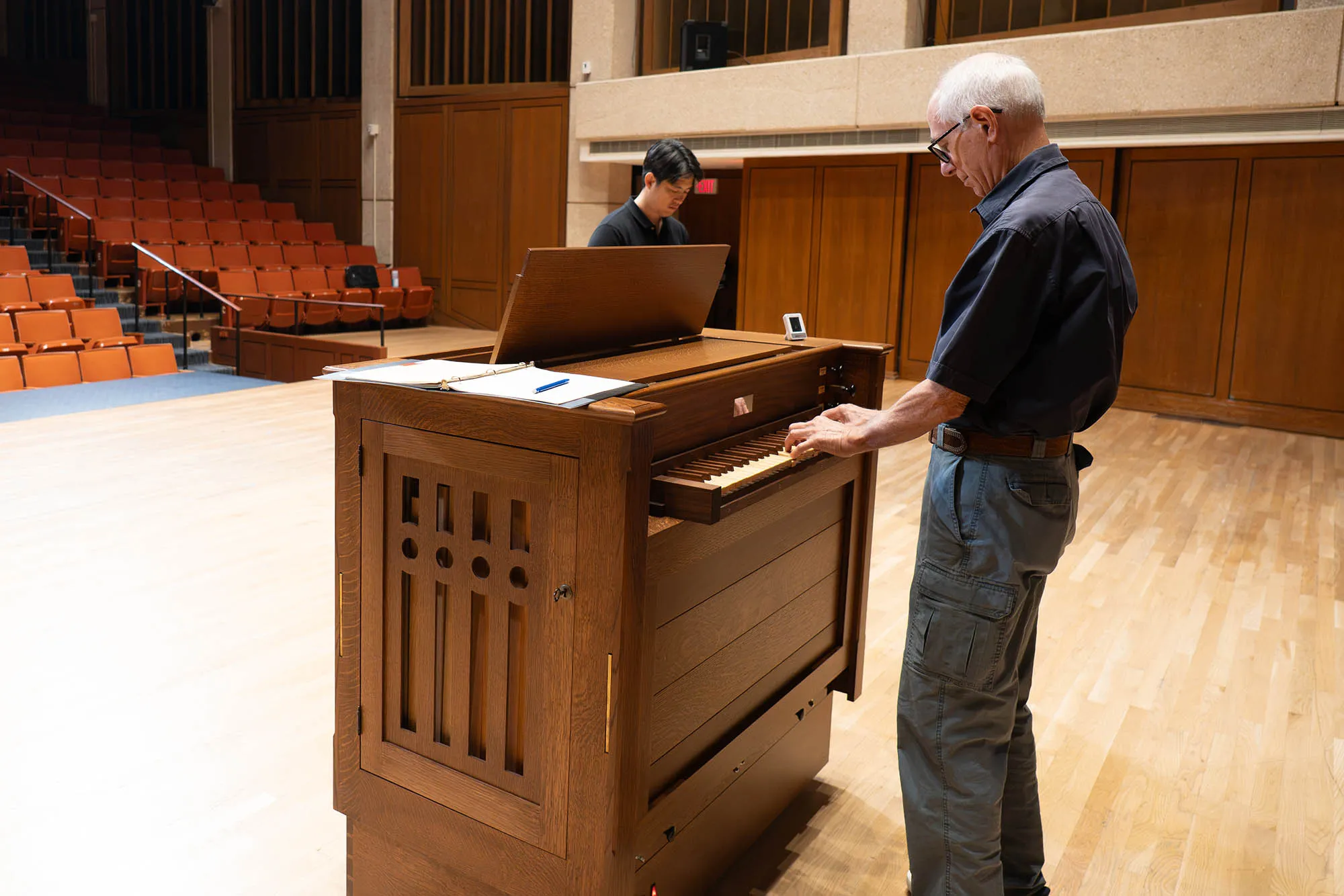Small organ being played in a concert hall