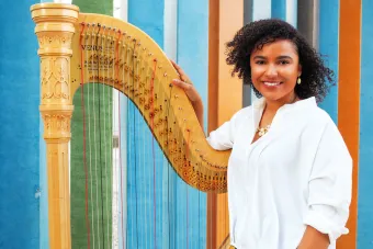 Mallory McHenry poses with harp