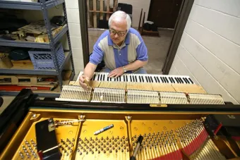 Charles Ball tuning a piano