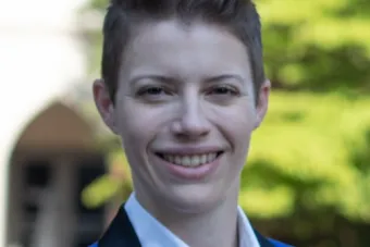 Headshot of tuba player Gretchen Renshaw standing outside in front of a tree.