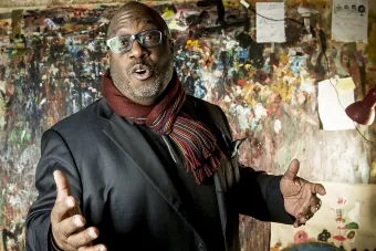 Jazz drummer Carl Allen wearing a scarf and talking to the camera.
