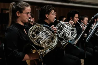A close up of horn players during a Symphony Band performance