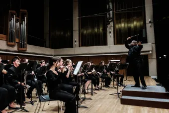 Clifford Croomes dynamically cues the brass section in a spirited passage at a Symphony Band Concert.