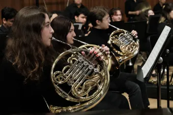 The horn section of Wind Symphony during a performance in Bates Recital Hall