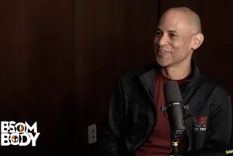 Charles Carson sitting with a microphone