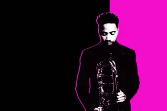 Black and white photo of a student holding his trombone in front of a magenta and black background.