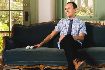 Ivan Trevino sitting on a couch with drum mallets