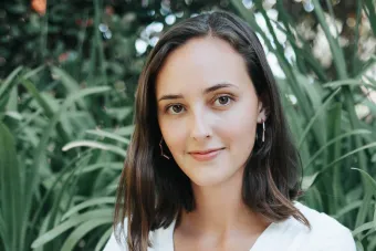 Indigo Fischer looking at the camera with trees in the background