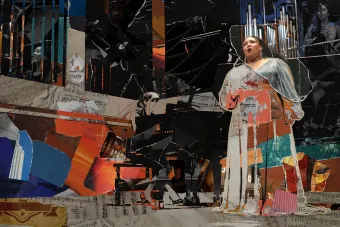 A collage of torn paper that creates an image of a singer and pianist on a concert hall stage